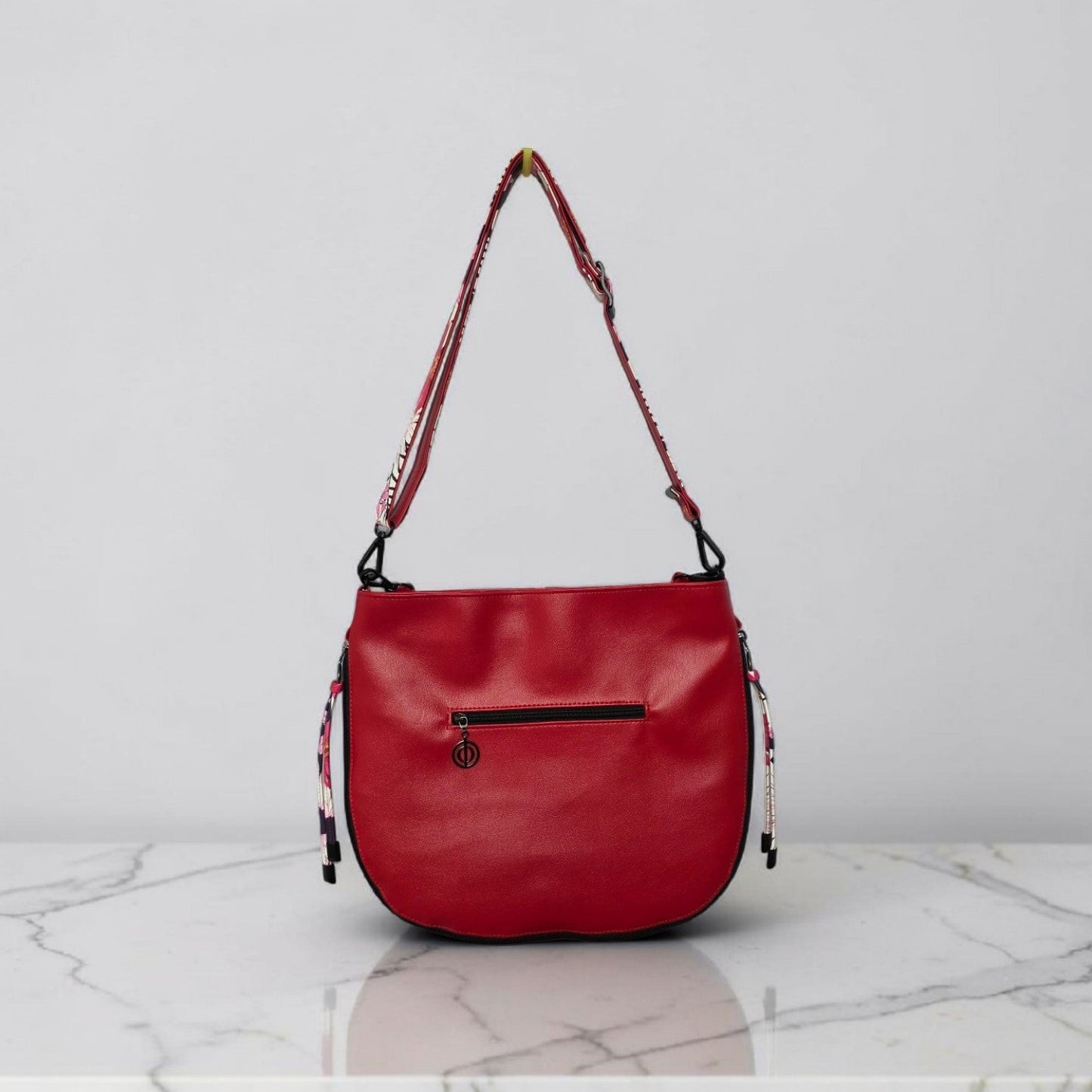 Red floral print slouch bag, matte black hardware.