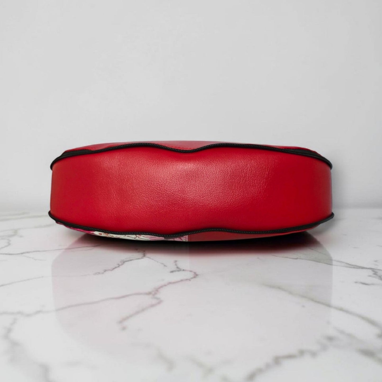 Red floral print slouch bag, matte black hardware.