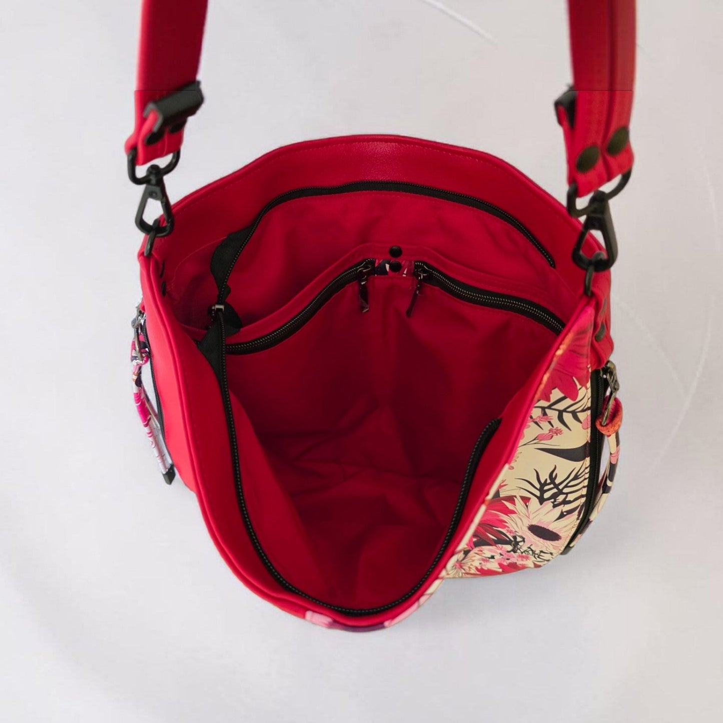 Red floral print slouch bag, matte black hardware.