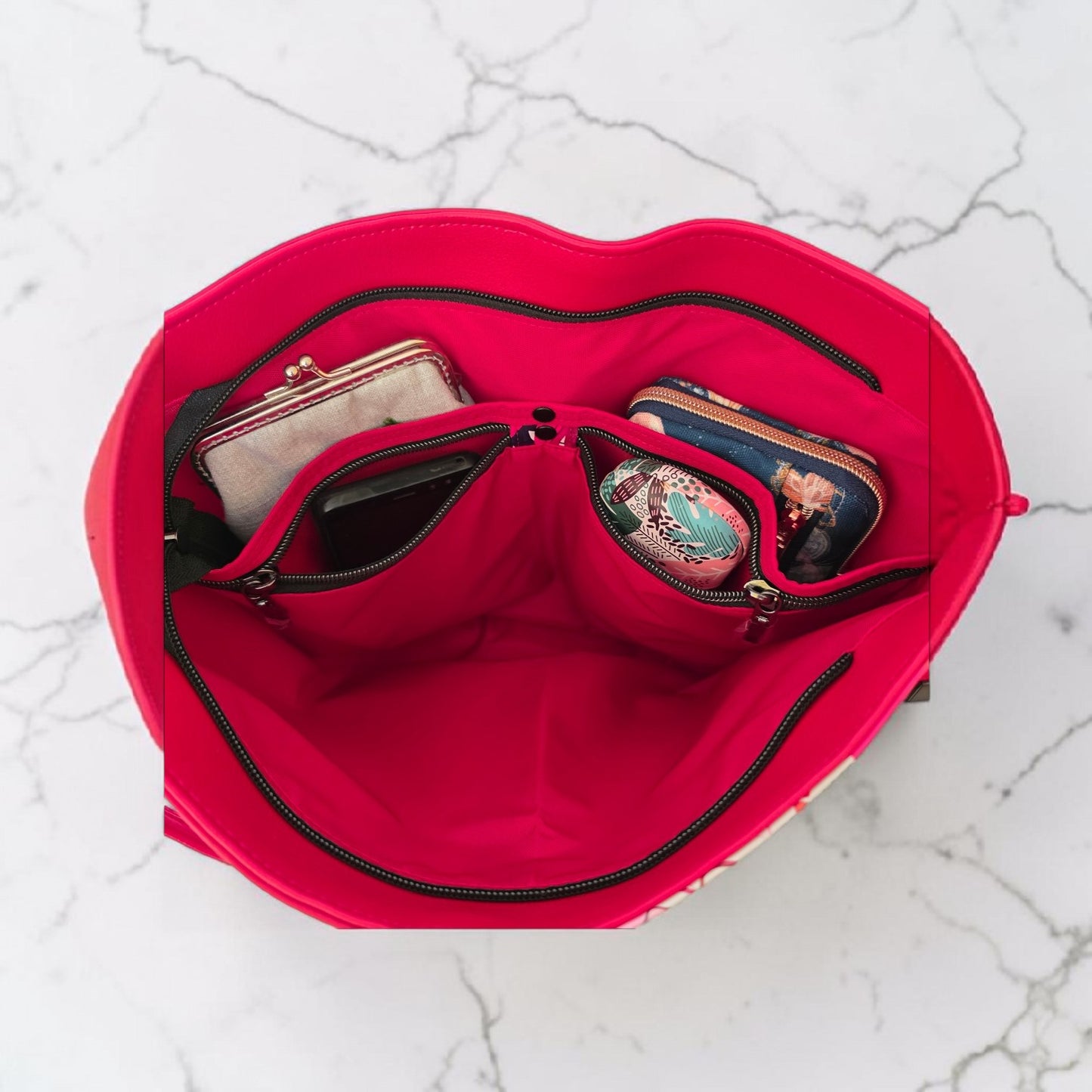 Red floral print slouch bag, matte black hardware.