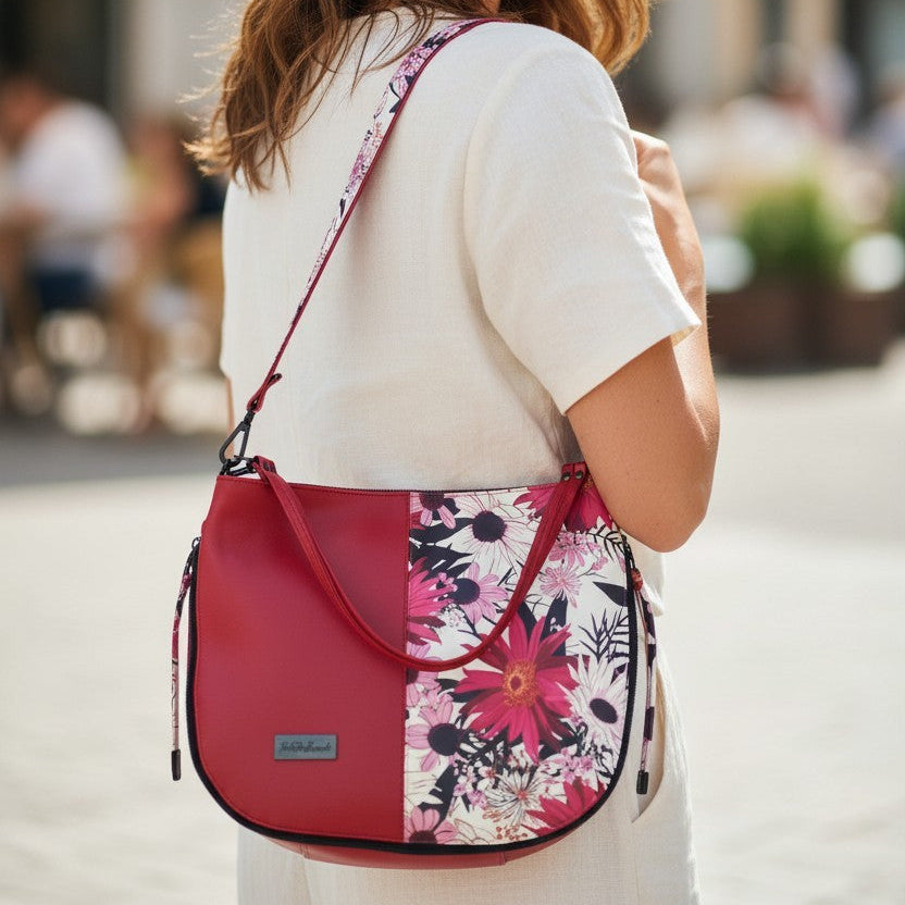Red floral print slouch bag, matte black hardware.