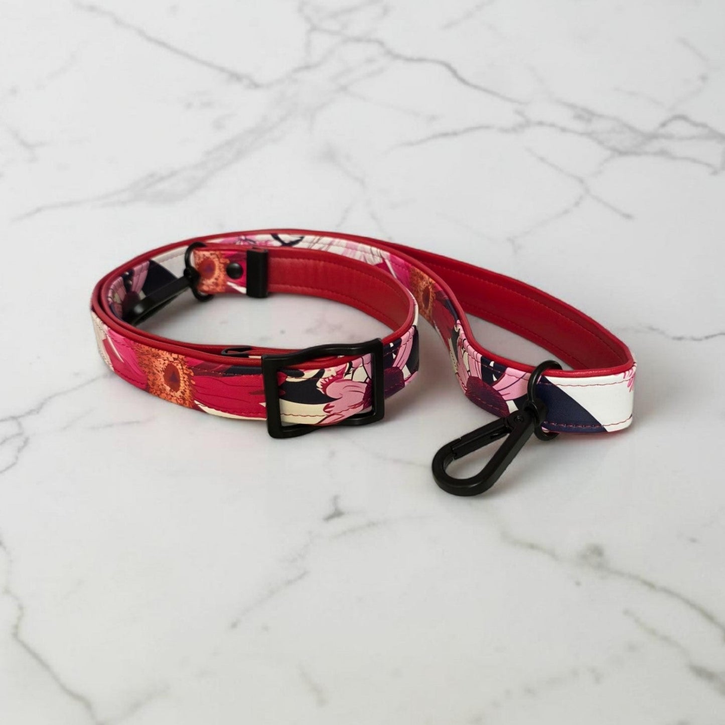 Red floral print slouch bag, matte black hardware.