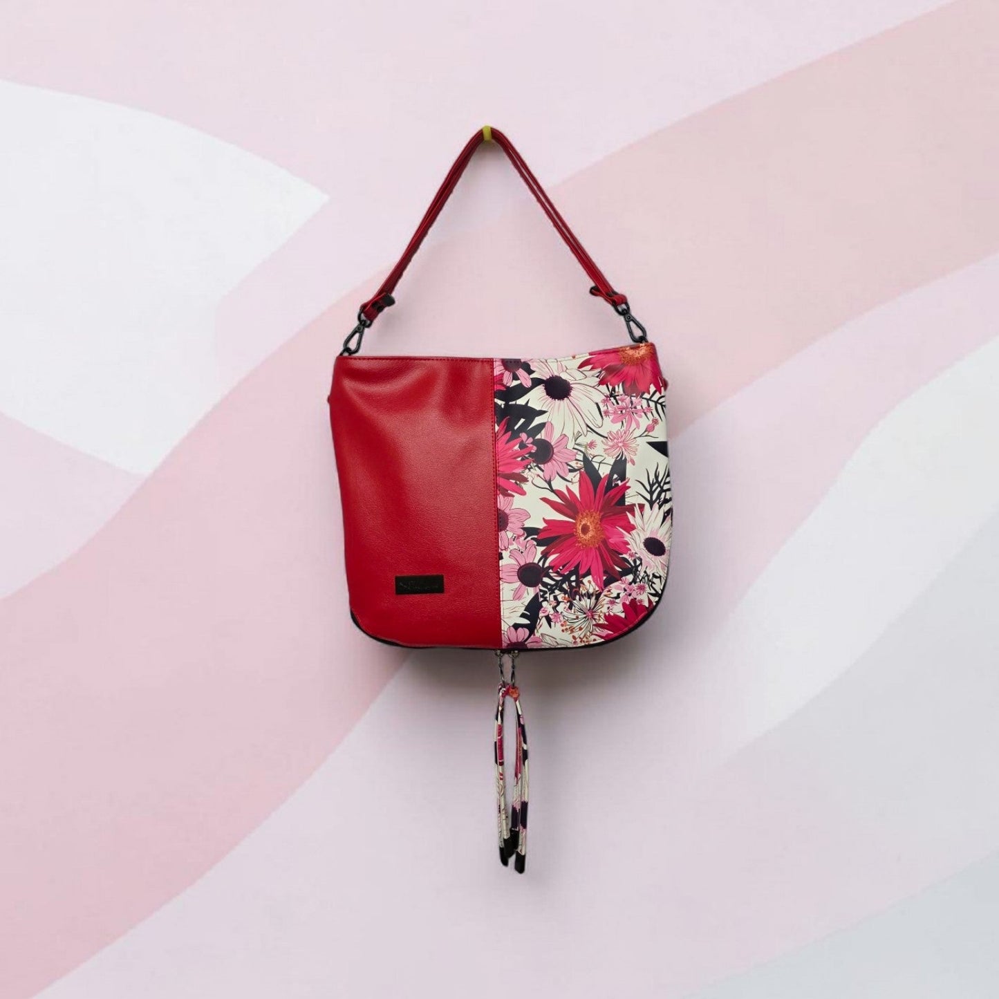 Red floral print slouch bag, matte black hardware.